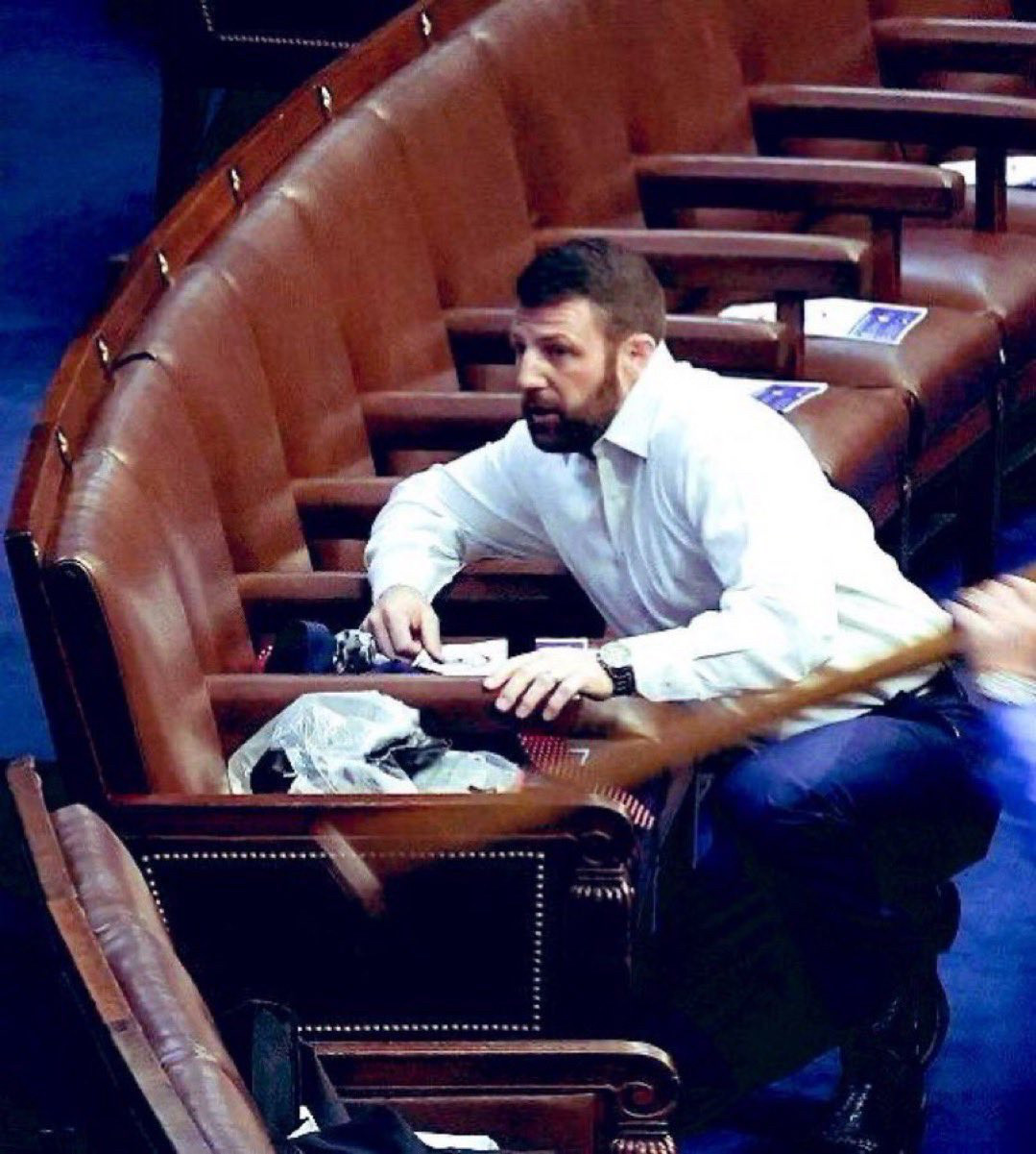 A photo of Senator Markwayne Mullin hiding like a fucking coward during January 6th.