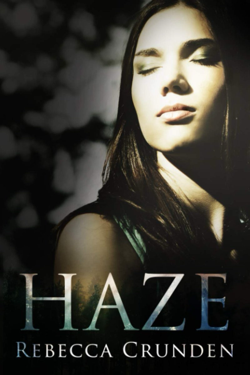 cover for haze by rebecca crunden; shows a girl with long brown hair, eyes closed, trees line the bottom and background.