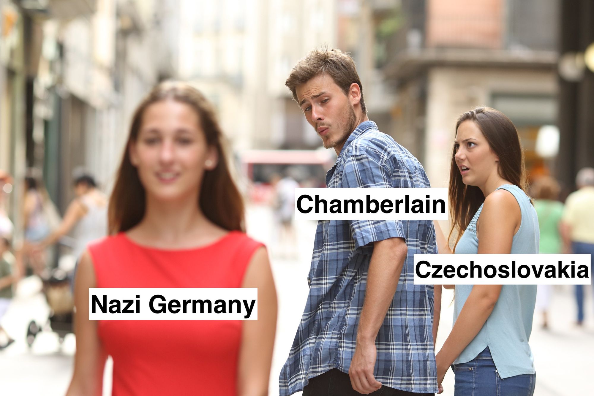 the "distracted" meme, i which a man walks down a street with one woman and turns around to stare admiringly at another woman passing by, whereupon the first woman stares at him, open-mouthed in disbelief

the man is labeled England
the first woman is labeled Czechoslovakia
the second woman is labeled Nazi Germany