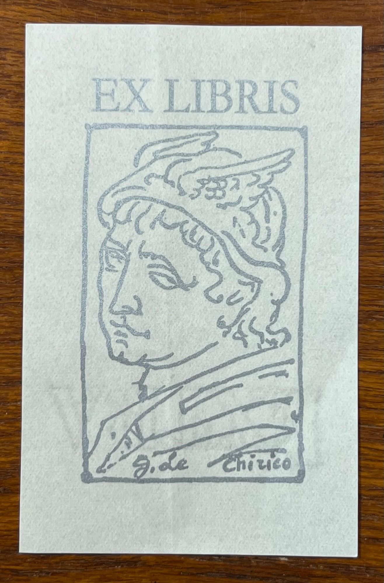 ex libris bt Giorgio de Chirico (1888-1978)

helmeted head of Mercury looking to the left: silver-gray ink on light gray-blue paper, signature at bottom

de Chirico is best known for modernist "metaphysical" art that inspired the Surrealists ,but after World War I he turned to neo-Baroque and neo-Classical aesthetics