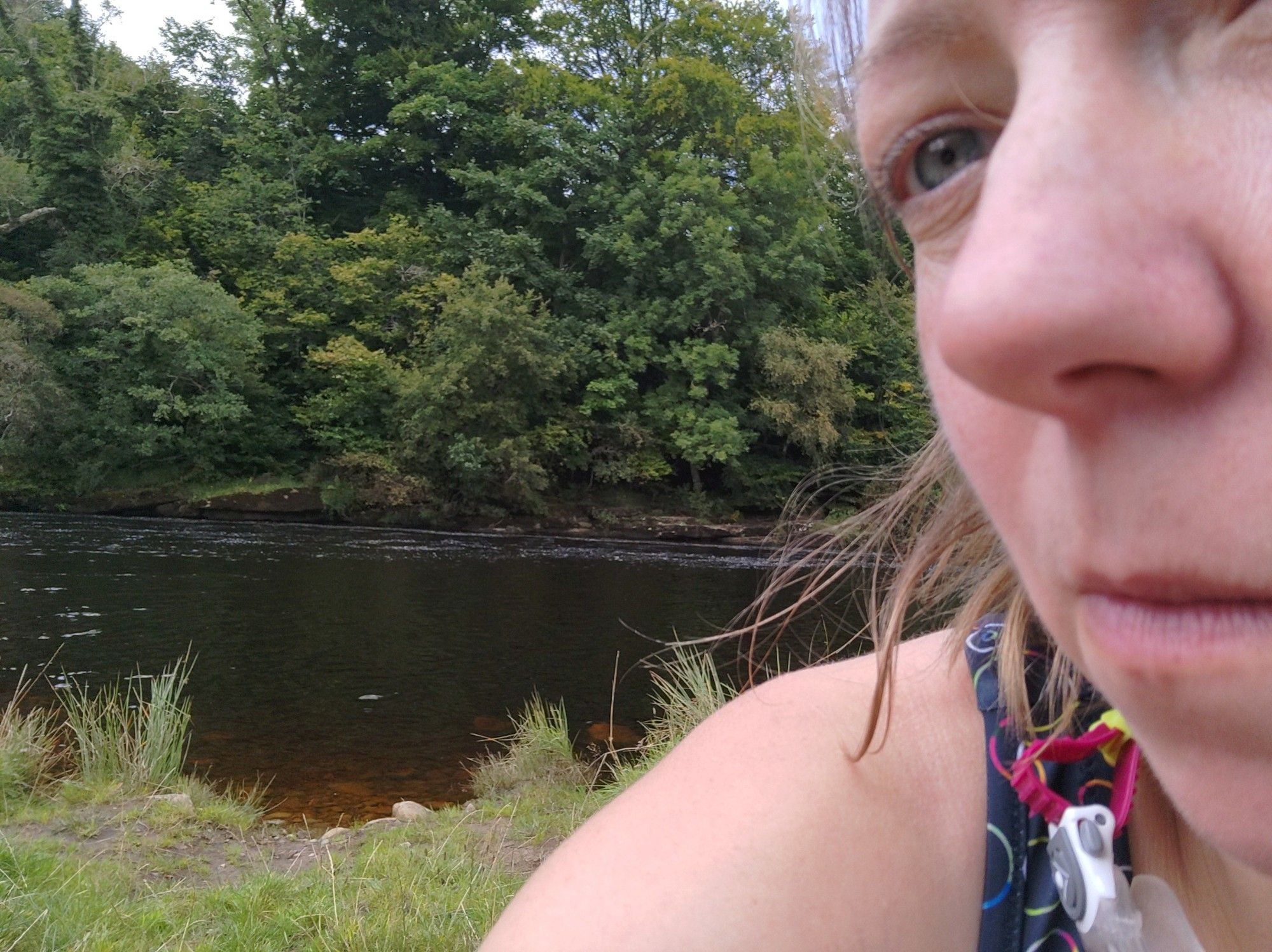 Tributary of the River Tyne, over the shoulder of a swimmer