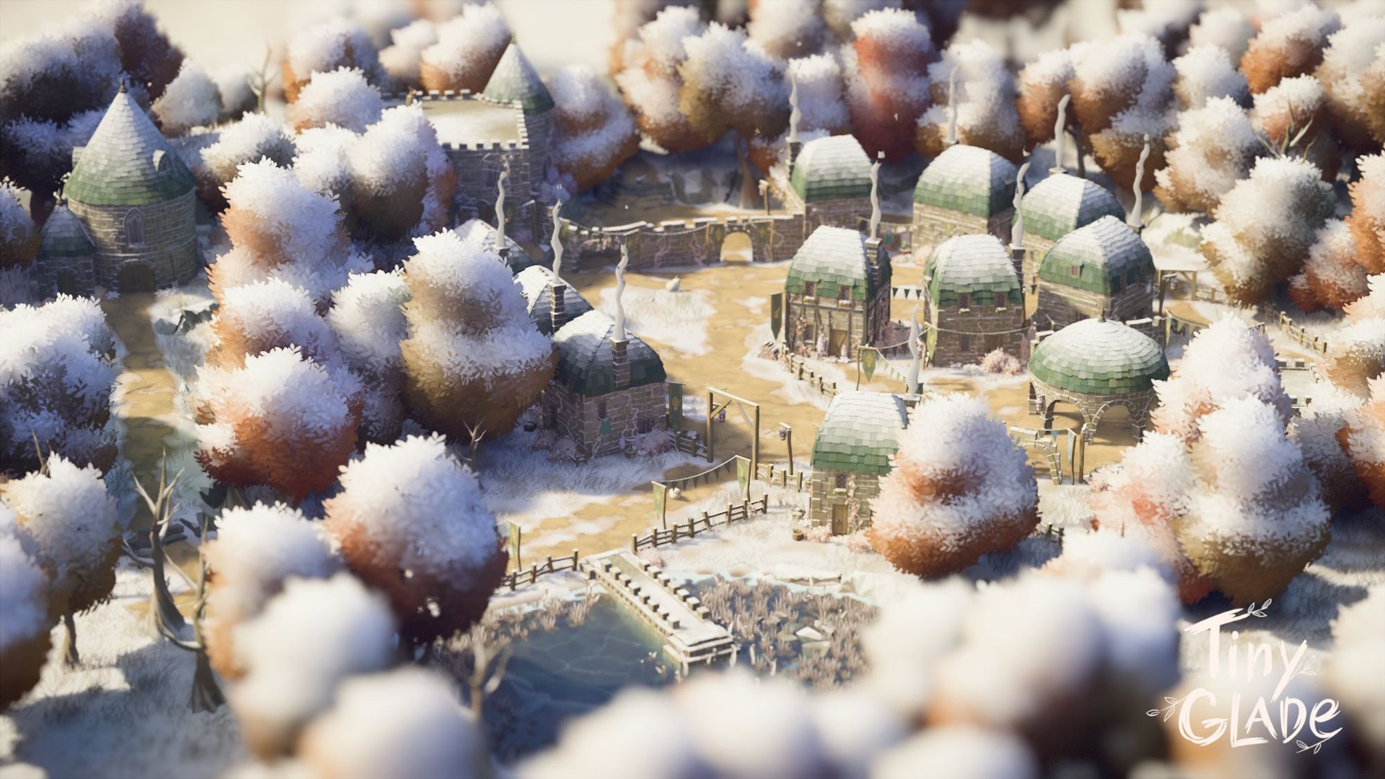 Areal view of a snow-covered settlement in the daytime. The settlement contains houses, a circular pavilion, a large castle-like structure, a tower hidden amongst the trees, and a small lake which has frozen over.