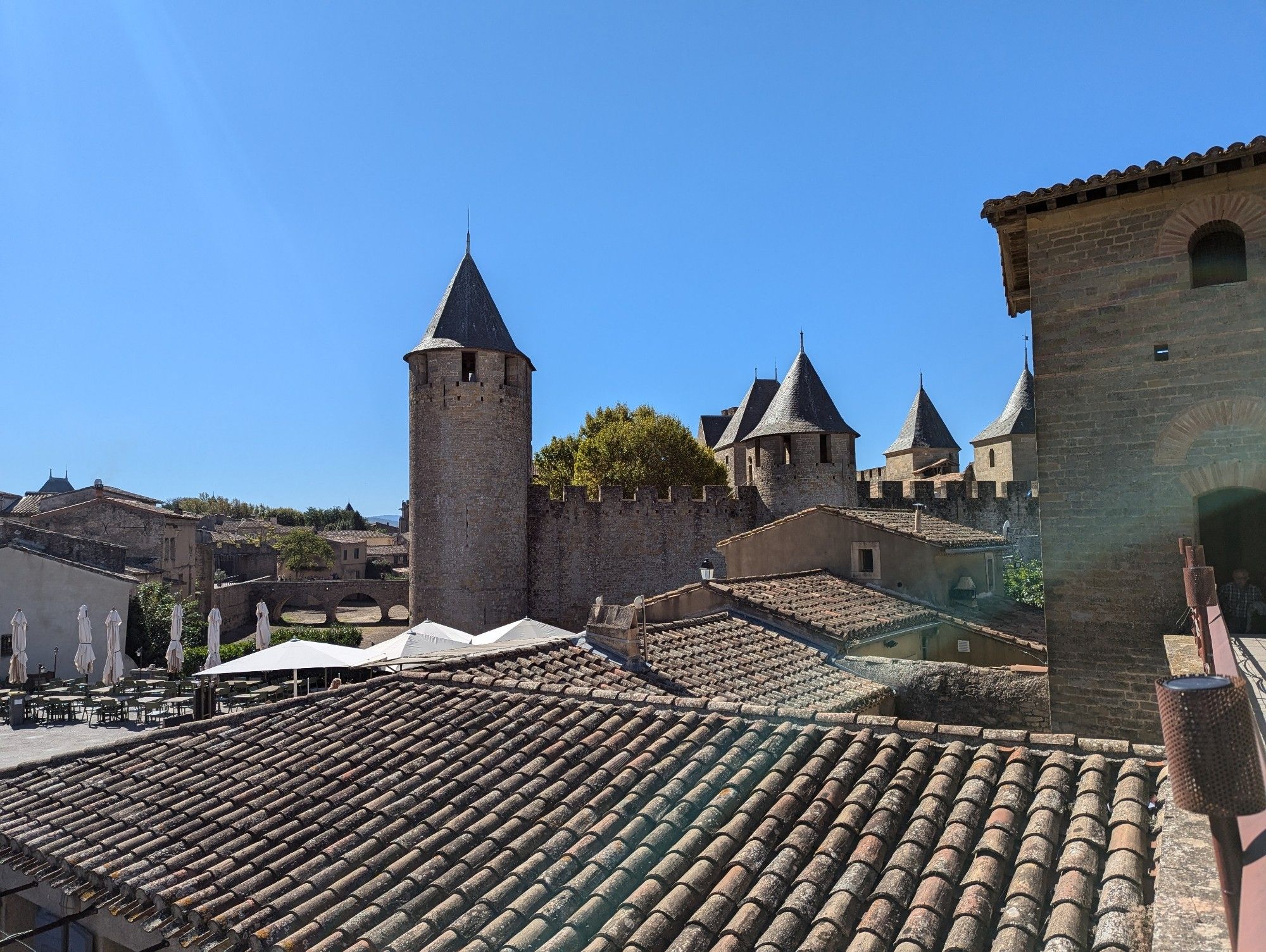 Look back across roofs towards a towered castle