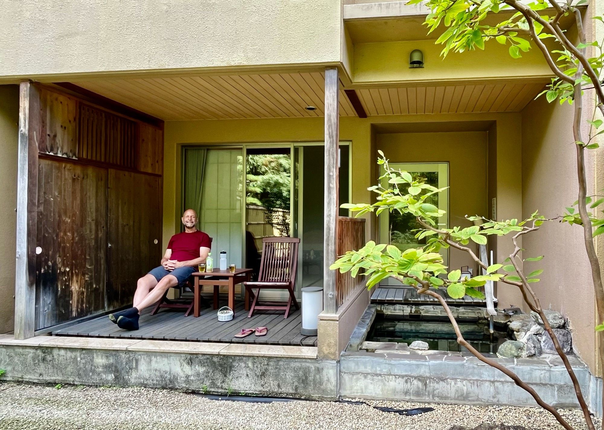 John hanging out on our terrace, our outdoor hot spring-fed bath to the right. A relaxing time!