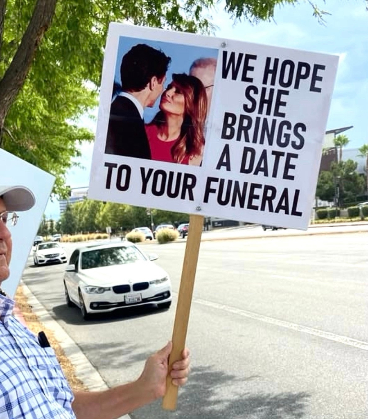 WE HOPE SHE BRINGS A DATE
TO YOUR FUNERAL
Protests sign with $melania’s picture