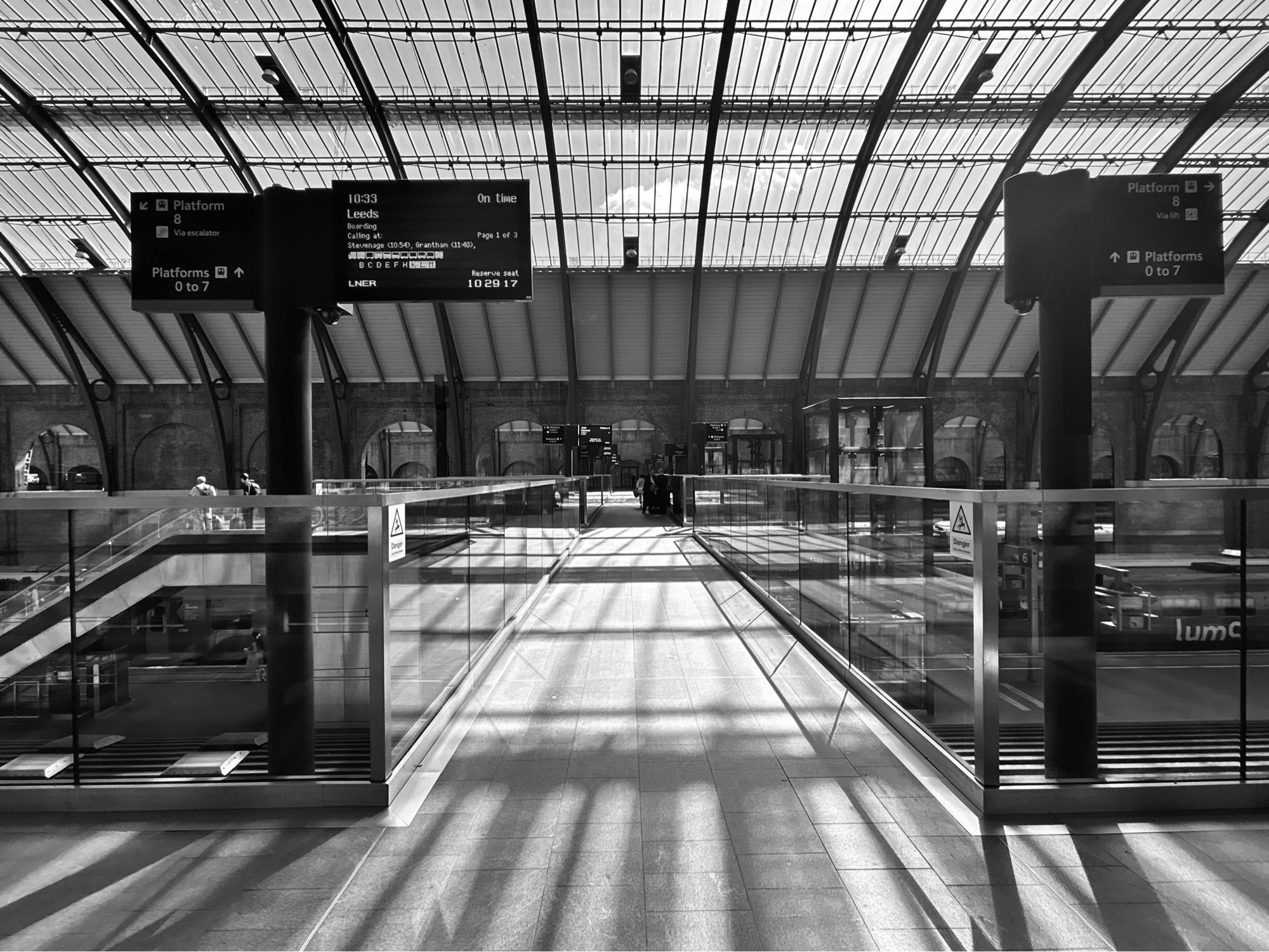 Very sunny view of shadow  across the station interior bridge