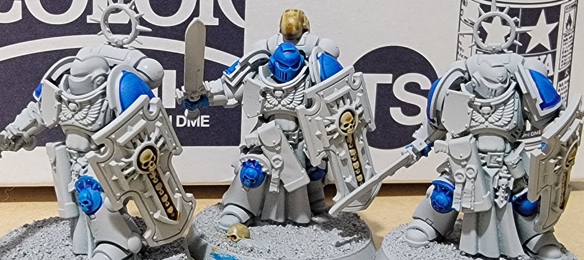 Three semi painted Bladeguard veterans for warhammer 40k standing in front of a tamiya spray paint box