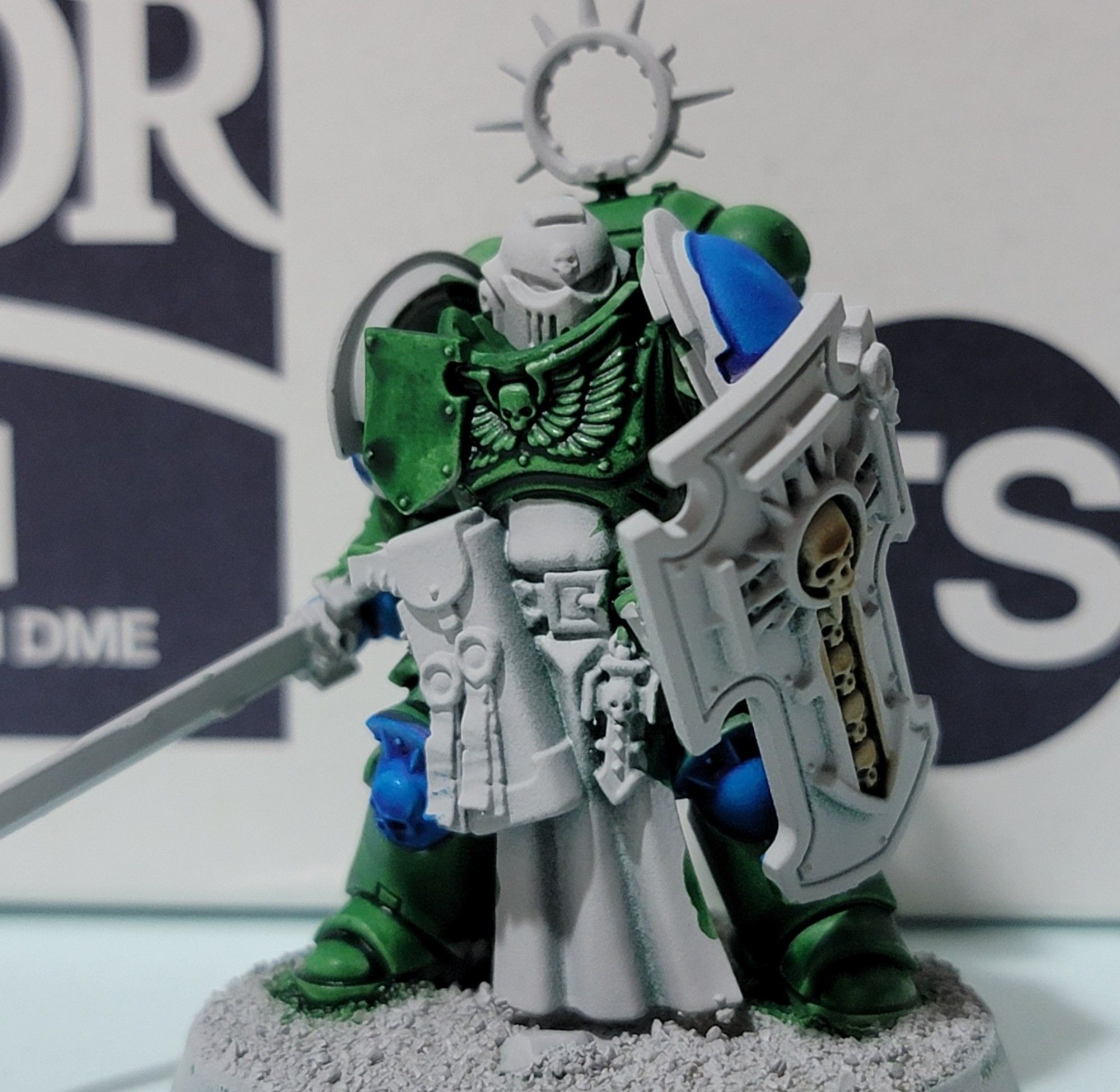 A single Bladeguard veteran with most of their armor painted green, blue, and white