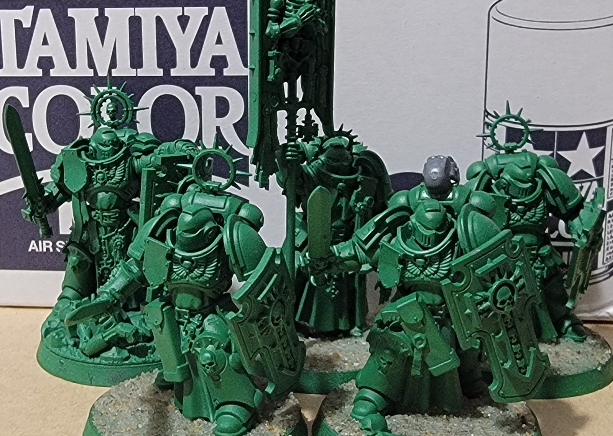 A Bladeguard Captain, a Bladeguard Ancient, and three Bladeguard veterans all primed in Army Painter Green spray