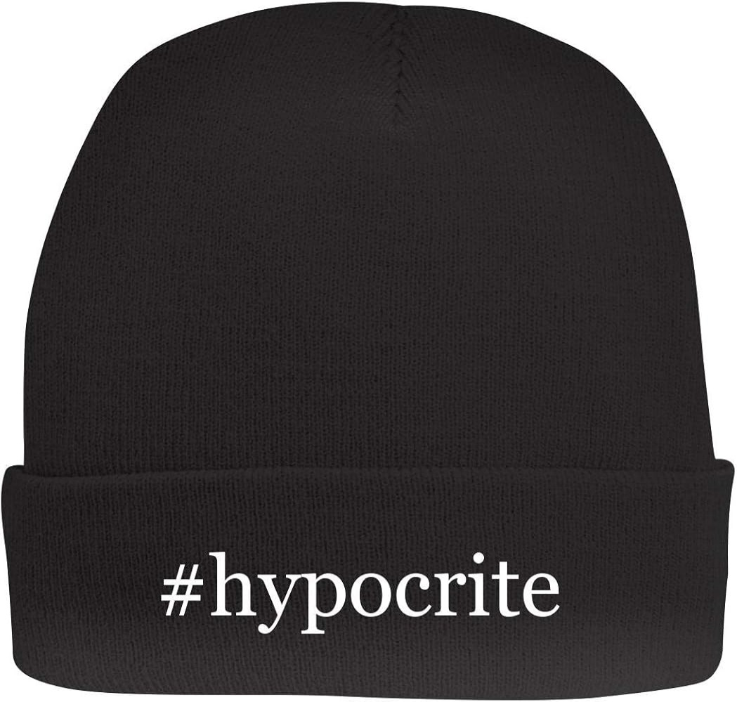 A dark beanie type hat with the hashtag Hypocrite in white stitching.