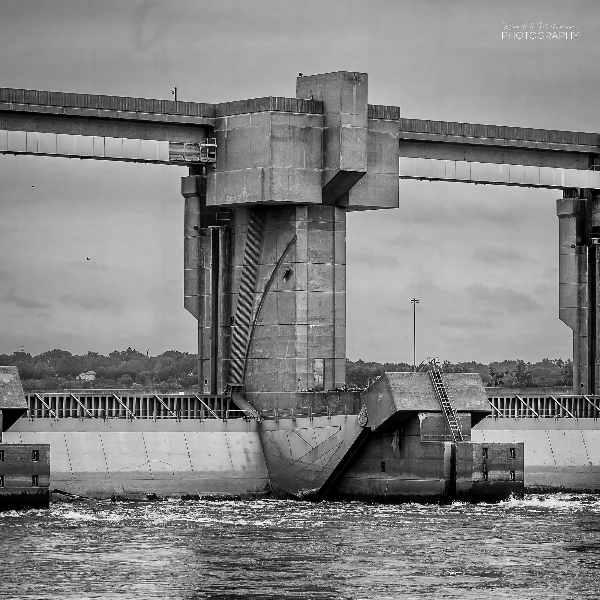 A view of the large movable gates between concrete towers of a dam on the Mississippi River.