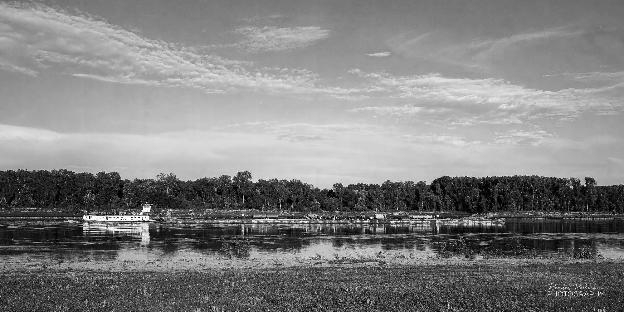 A tow named Mr. Lampton pushes barges up the Missouri River.