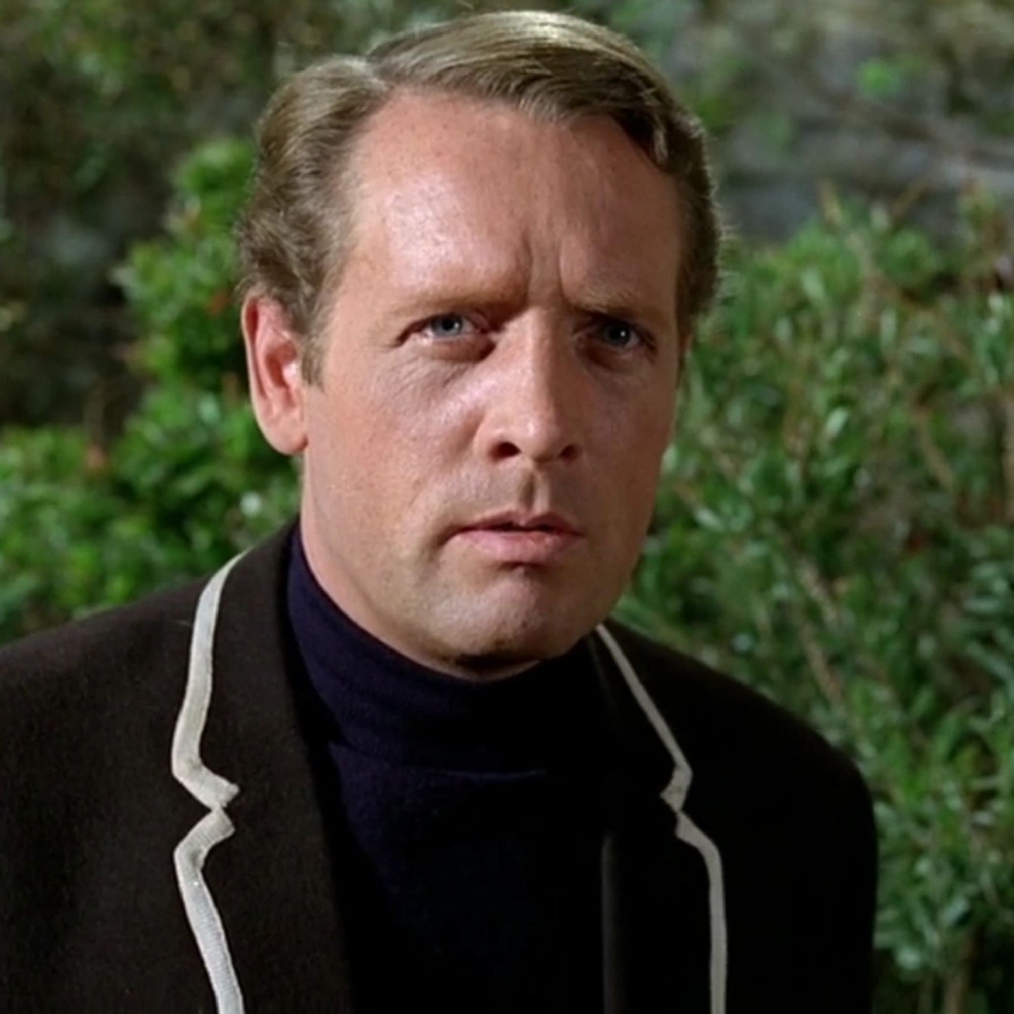 Patrick McGoohan in his The Prisoner blazer looking out of frame.