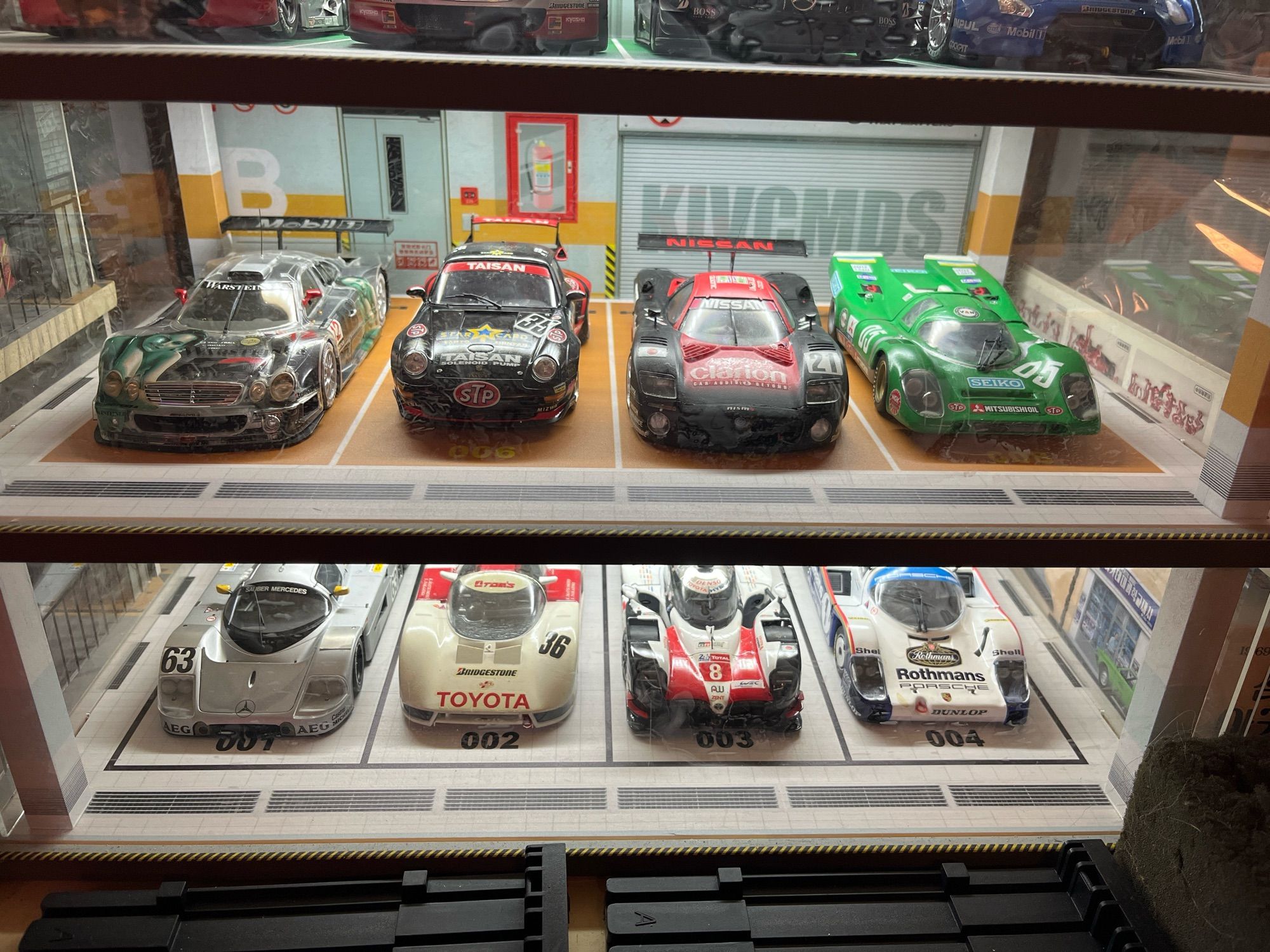 Middle shelf various LeMans and Super Gt racers.