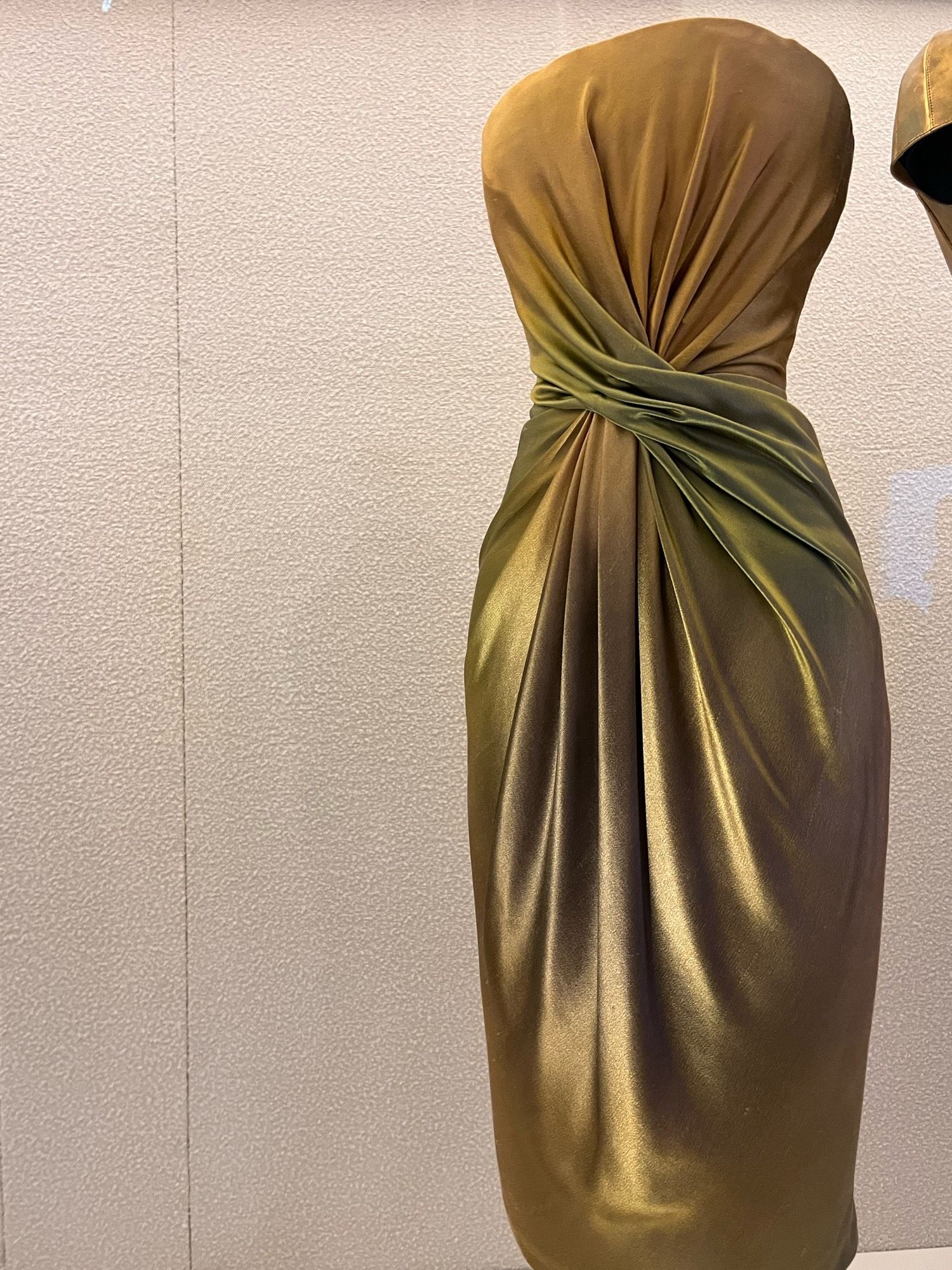 A strapless gold dress with knot.