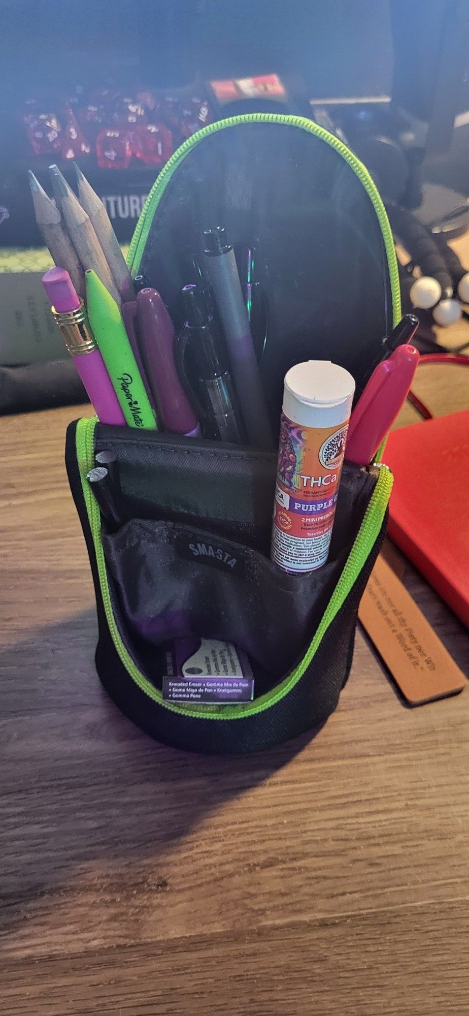 Then pencil holder folds open and locks via magnet into a vertical position with lots of room for pens and prerolls. It is the correct width to prop up a cellphone by design too