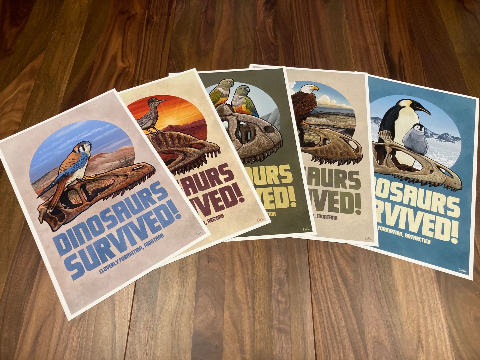 A collection of 5 11x17" posters that all say "Dinosaurs Survived!" and future modern day birds/dinosaurs sitting on top of dinosaur skull that have been discovered within their ranges.