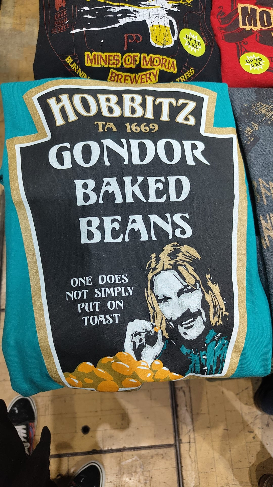 T-shirt in the style of Heinz baked beans label
Title - Hobbitz TA 1669
Gondor Baked Beans

Small print - One does not simply put on toast, picture of Sean Beans characters face (Boromir) next to some beans 