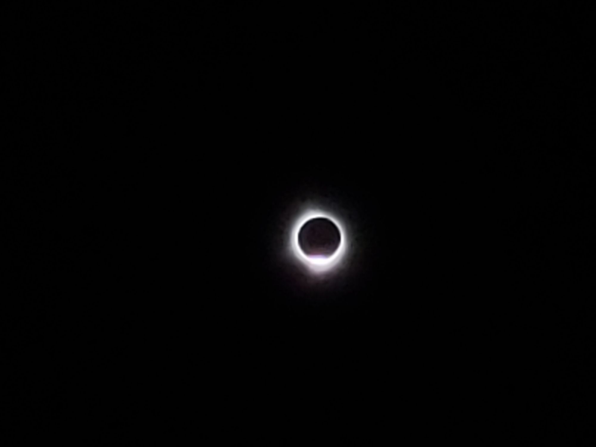 A total solar eclipse, just before the "diamond ring" effect appears near the bottom