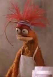 Pepe the king prawn is wearing a headband and white apron and looks completely baffled. Which, y'know, same. 