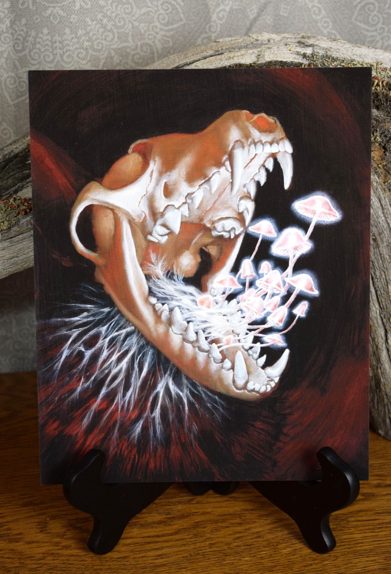 Art print of an artwork featuring a spooky fox skull with glowing mushrooms sprouting from its mouth.