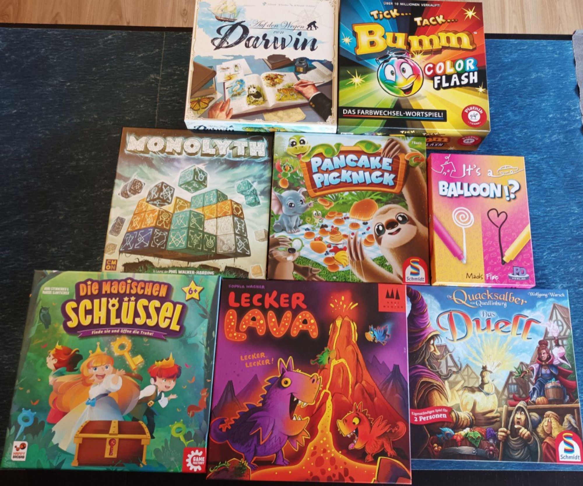 8 Brettspiele mit Cover. Die magischen Schlüssel, Lecker Lava, Quacksalber das Duell, Monolyth, Pancake Picknick, Its a Balloon, Auf den Wegen von Darwin und Tick tack Boom color flash