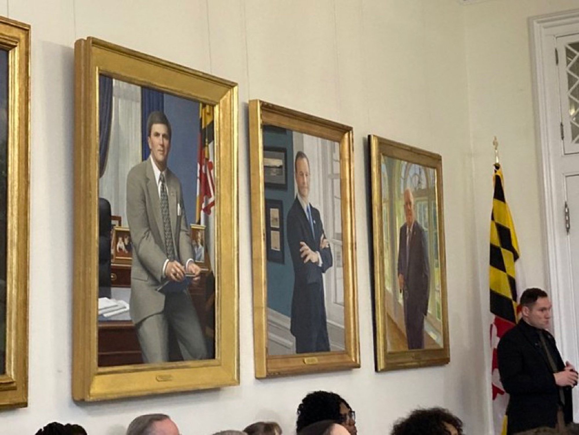 Portraits hanging on a wall of Governors Ehrlich, O’Malley and Hogan.