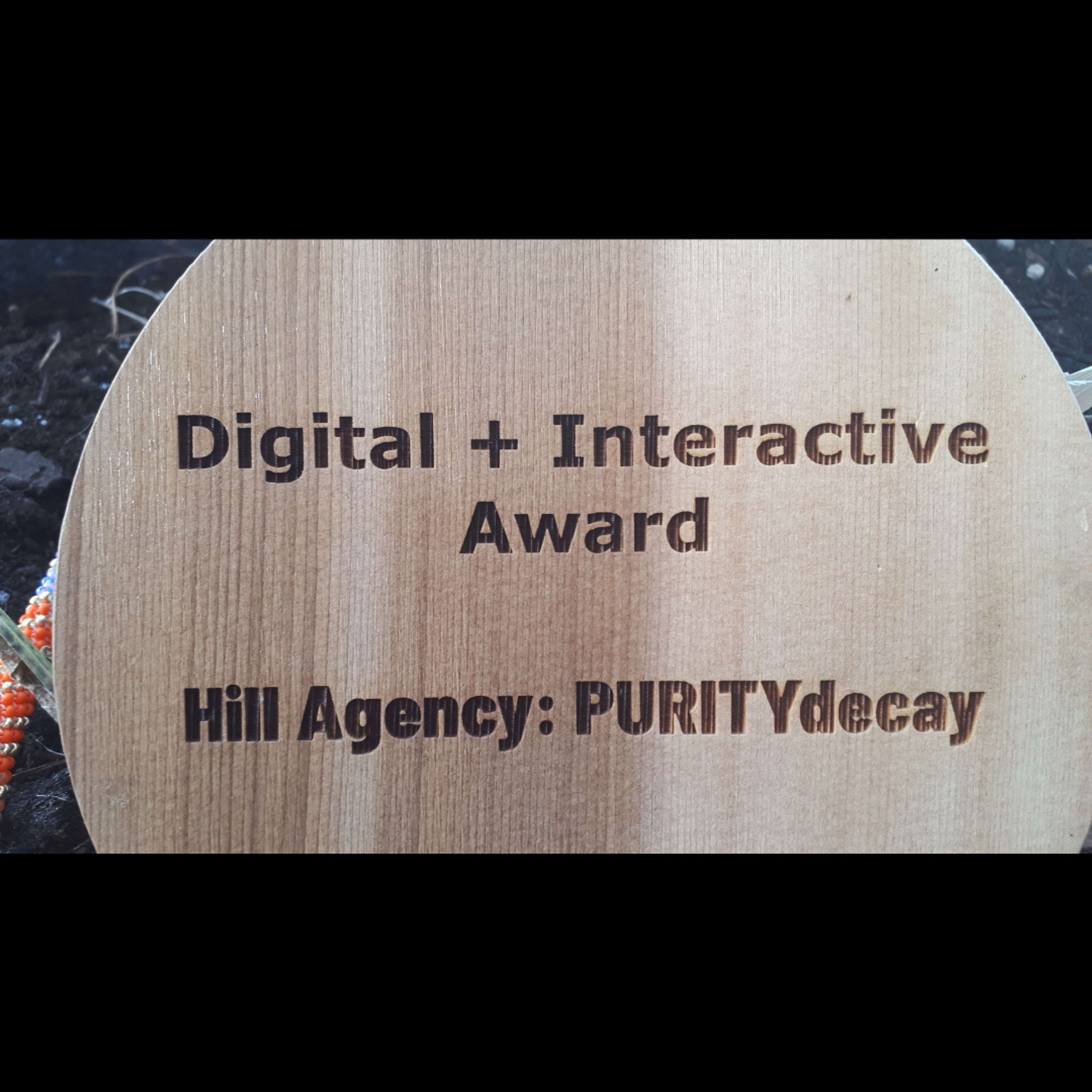 Back of the award, with Digital + Interactive Award written on the top and Hill Agency: PURITY/decay written on the middle