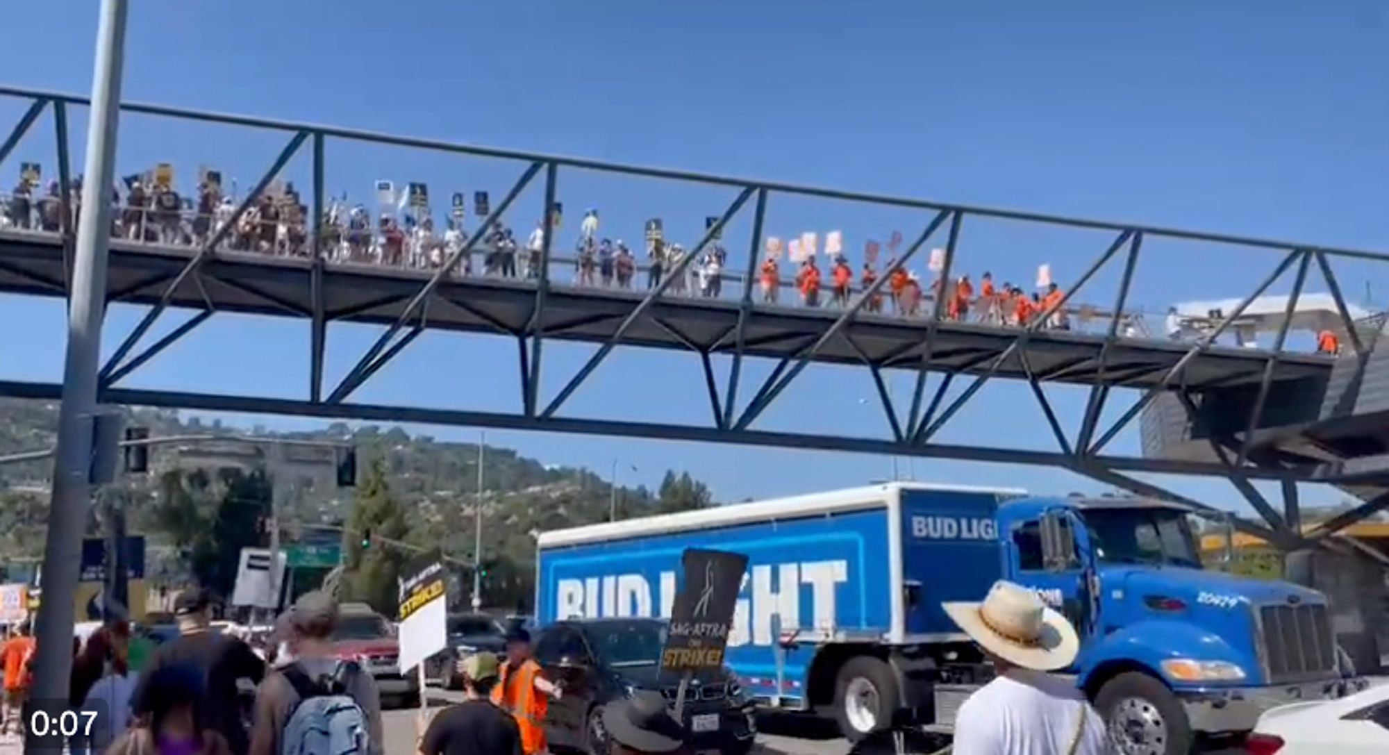 packed pedestrian bridge above universal studios