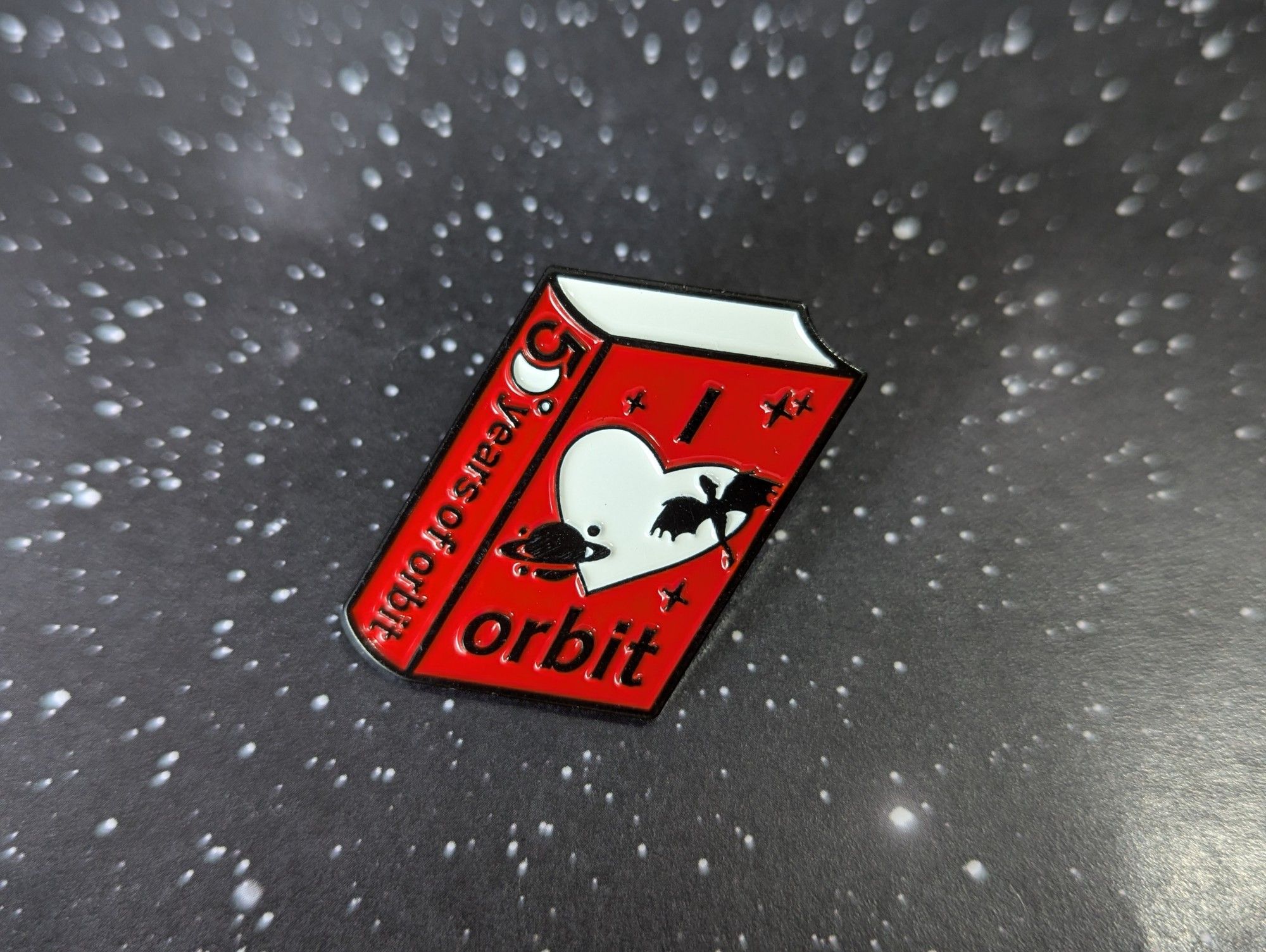 Pin badge - a small book titled I Heart Orbit