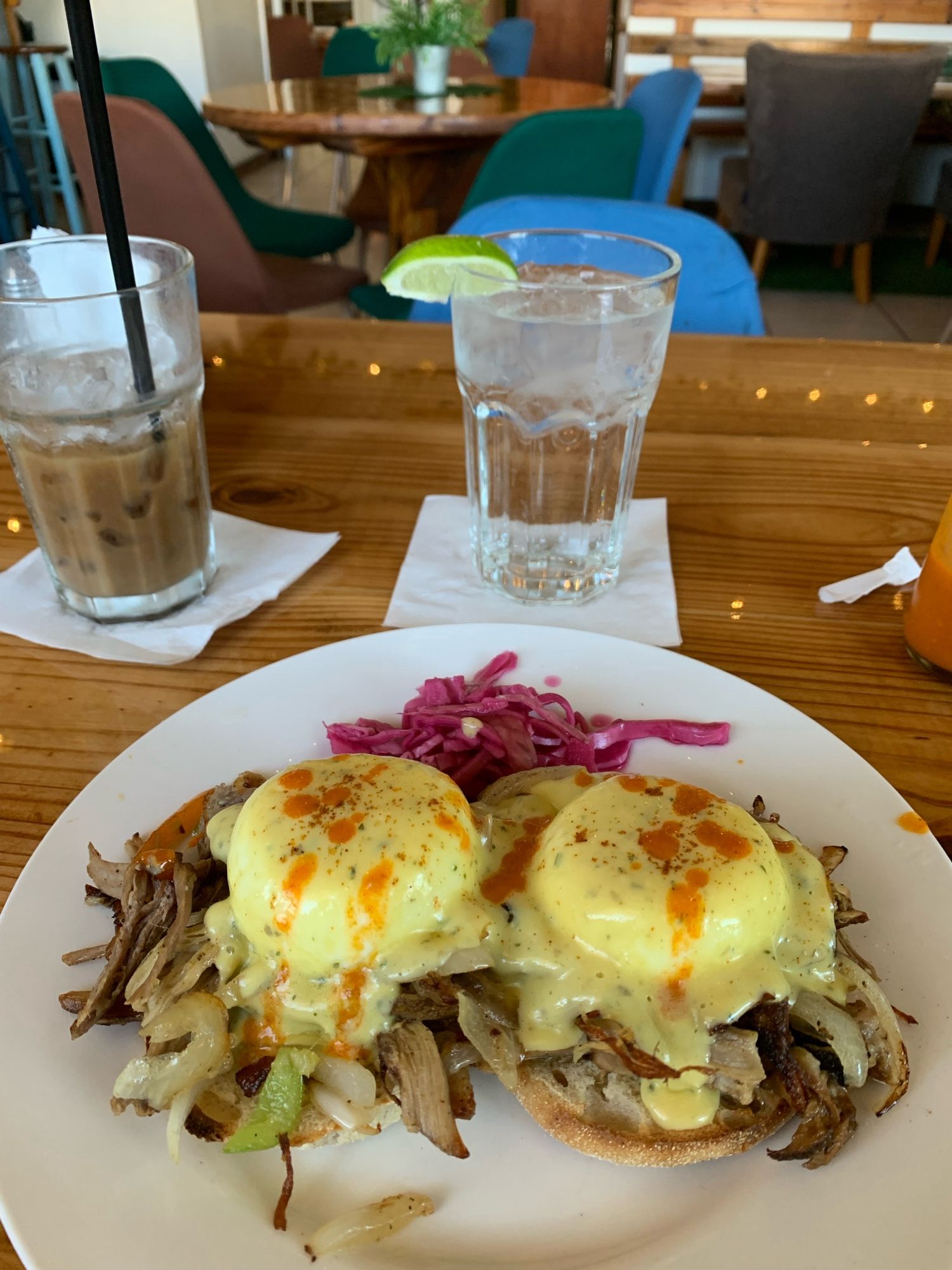 photo of breakfast including eggs benedict puerto rican style with iced coffee and a water at La Isla restaurant in Rincon, PR