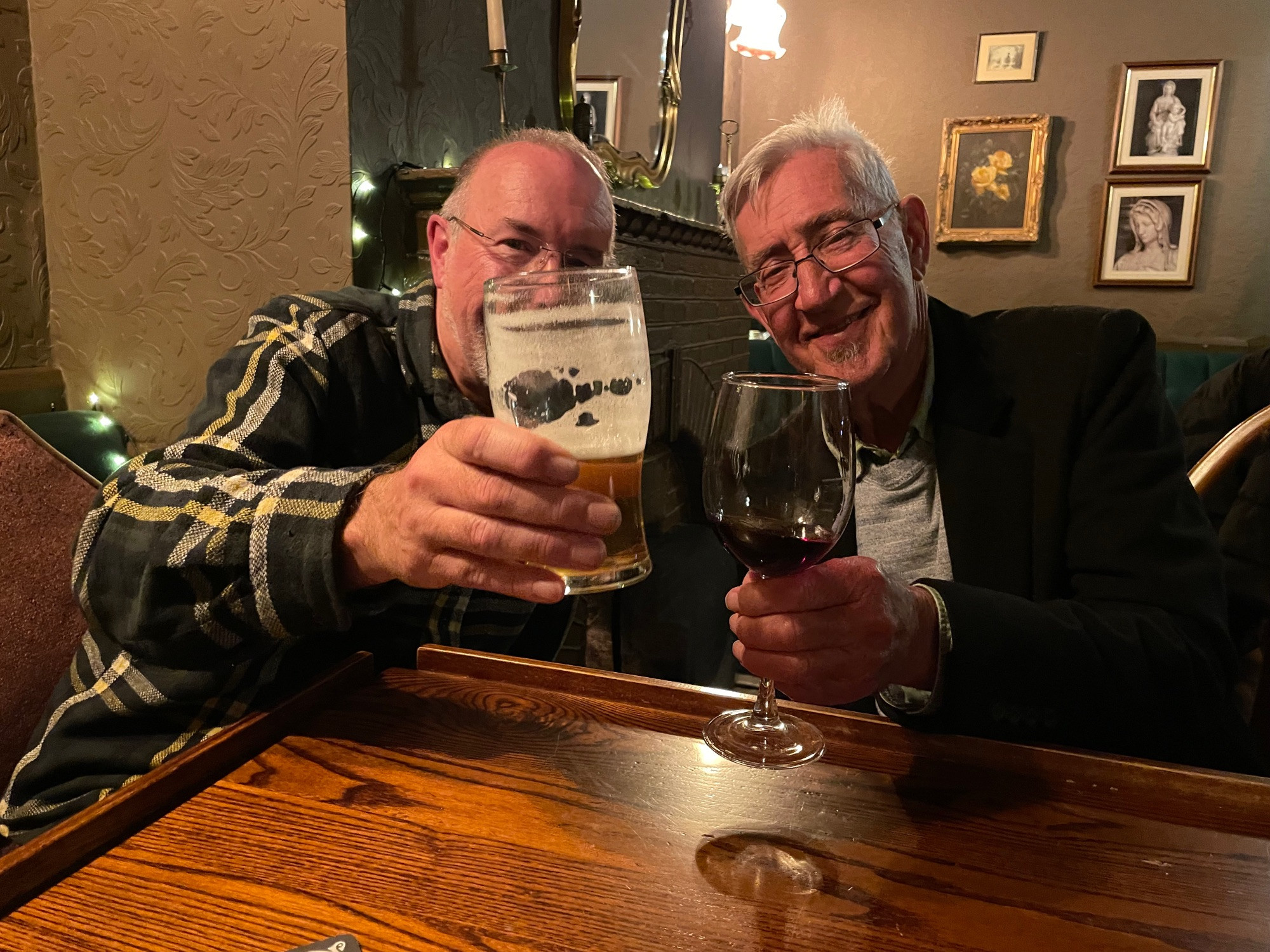 David Belbin and Michael Gray raising a glass to a friend in the bar beforehand.