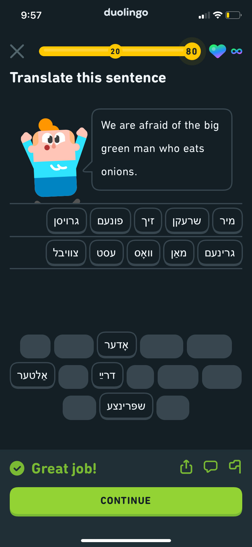 A screenshot of the Duolingo Yiddish course where the sentence being taught is "We are afraid of the big green man who eats onions."