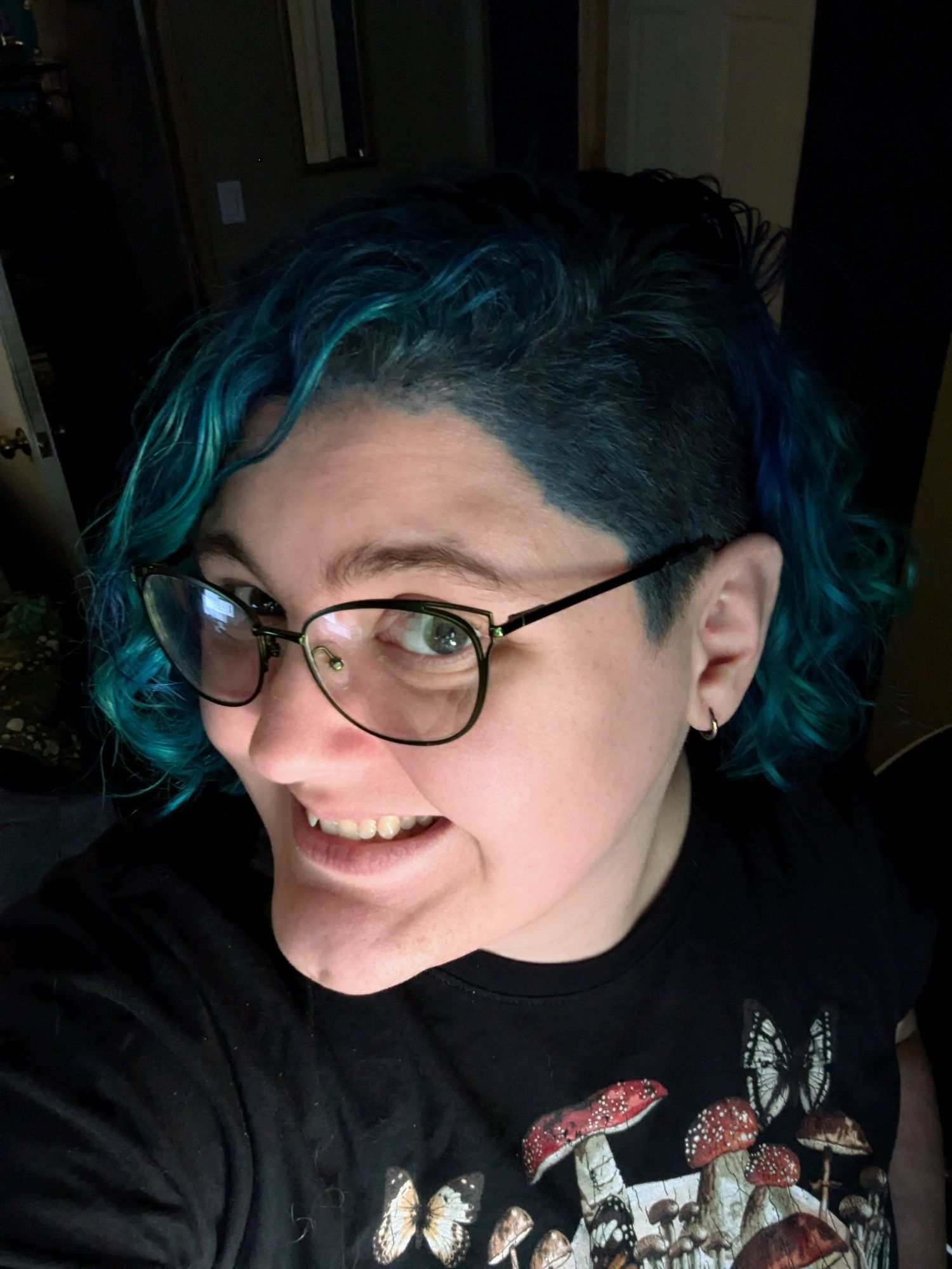 A selfie showing off the mermaid curls and crisp side buzz