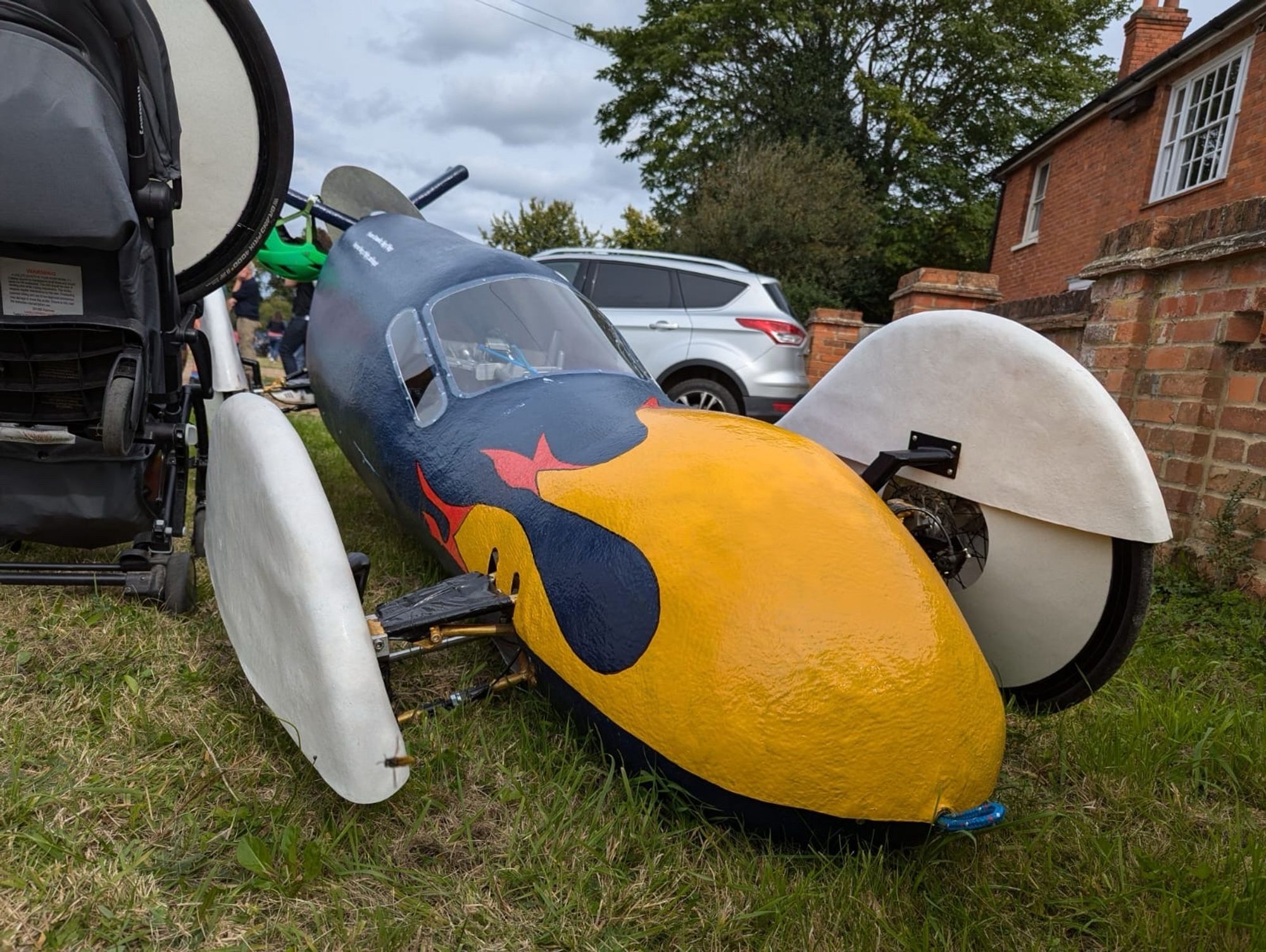 Gravity racer, with its front right wheel missing.