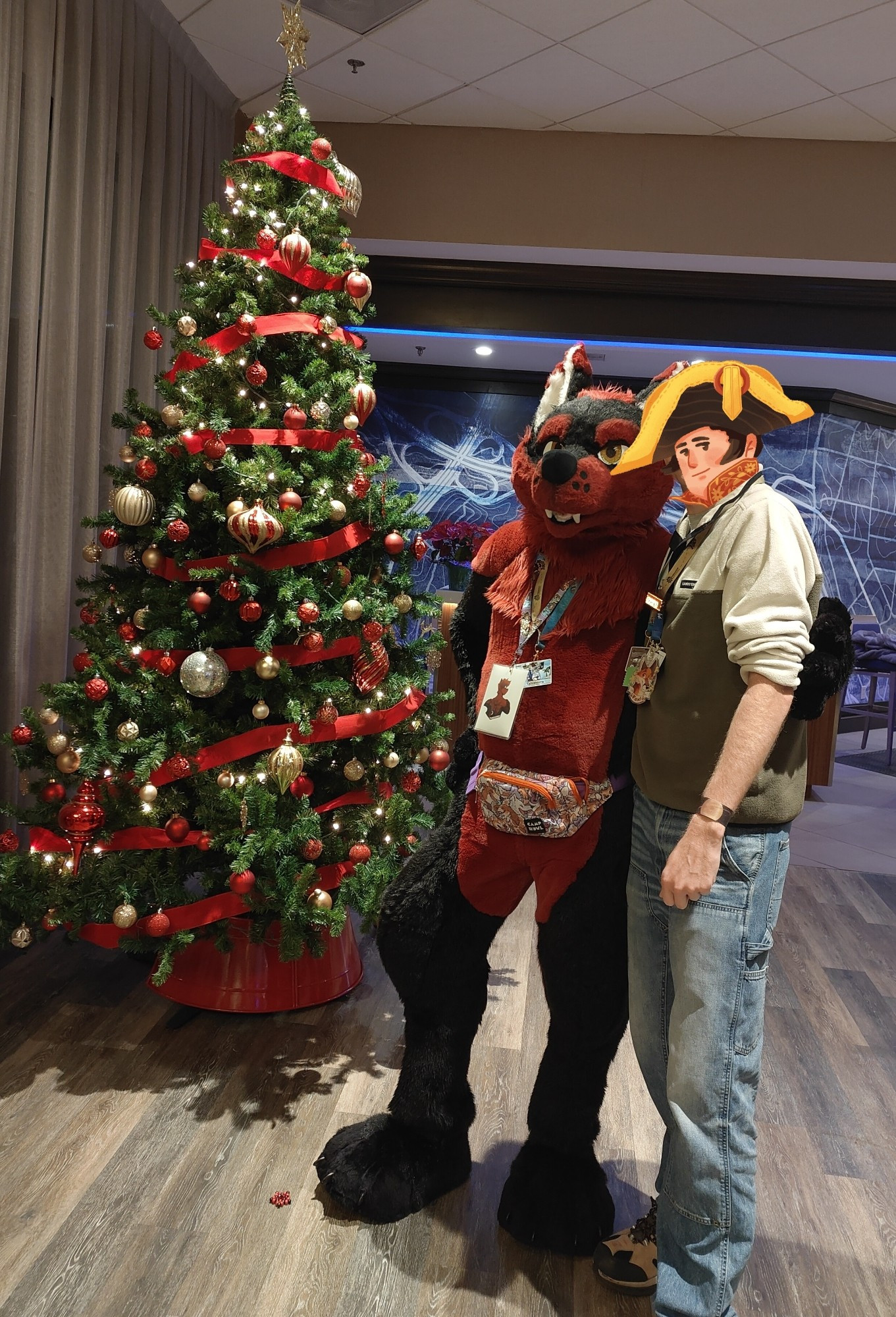 Tahlmorra and I were standing in the lobby at Bewhiskered beside a decorative fir tree for this photo. I have a silly sticker over my face.