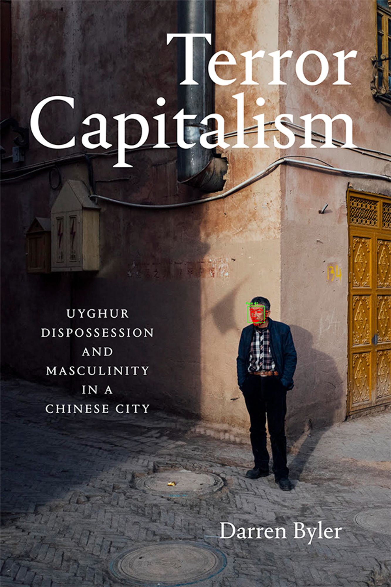 Cover of Terror Capitalism: Uyghur Dispossession and Masculinity in a Chinese City by Darren Byler. Cover features a piece from Maxime Matthys's 2019 art project, 2091: The Ministry of Privacy. The image depicts a man by a building, with facial recognition software homing in on his face.