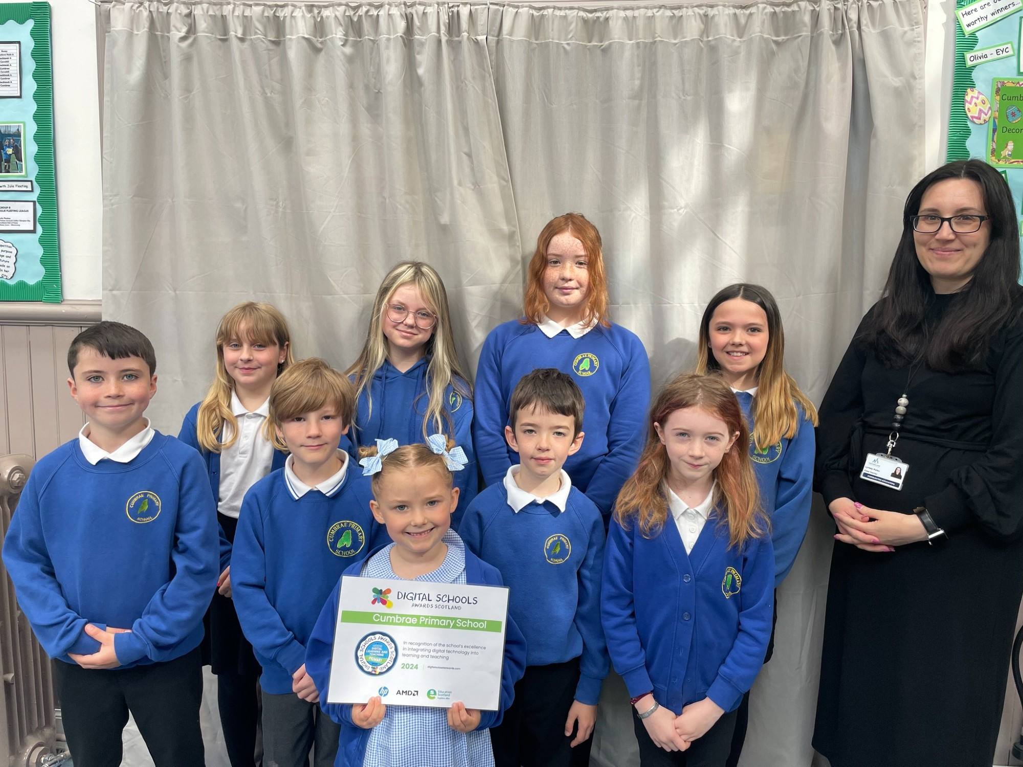 Ms Kelso Class Teacher receiving the Digital Schools Award with pupils from Cumbrae Primary School.