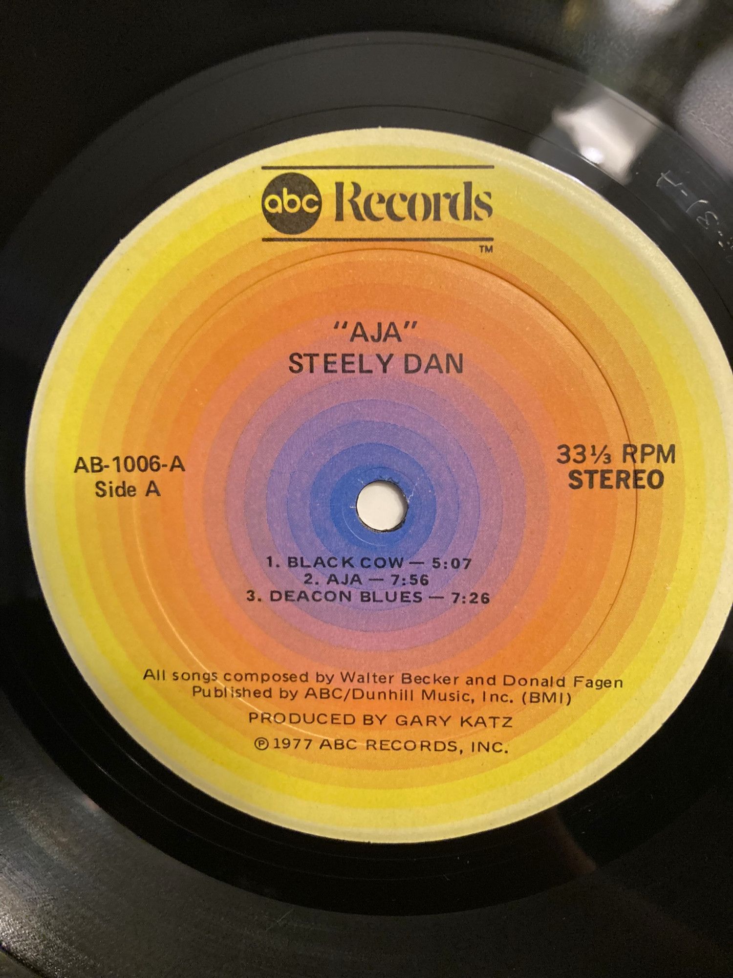 an original pressing of Steely Dan's "Aja" album, Side A, AB-1006-A