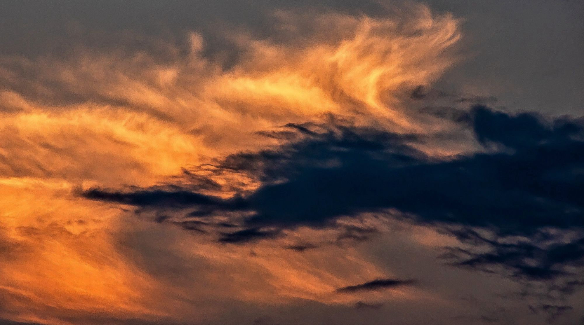 Dramatic multi-hued clouds light up the late evening skies over London, Ontario, Canada.