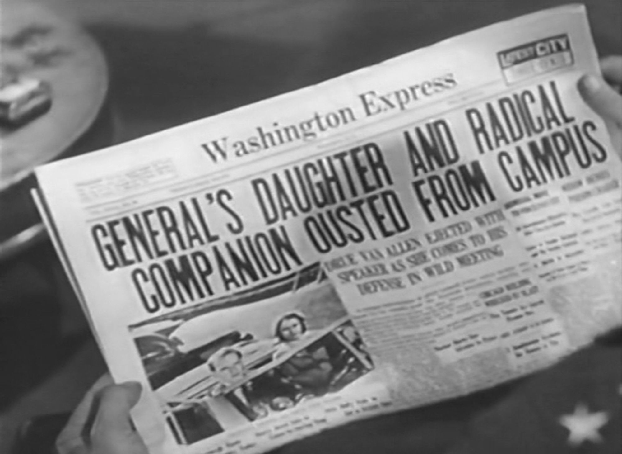 Red Salute (1935). A close up of a pair of hands holding a copy of the "Washington Express", which has on the front page a picture of Barbara and the activist with the headline, "GENERAL'S DAUGHTER AND RADICAL COMPANION OUSTED FROM CAMPUS"