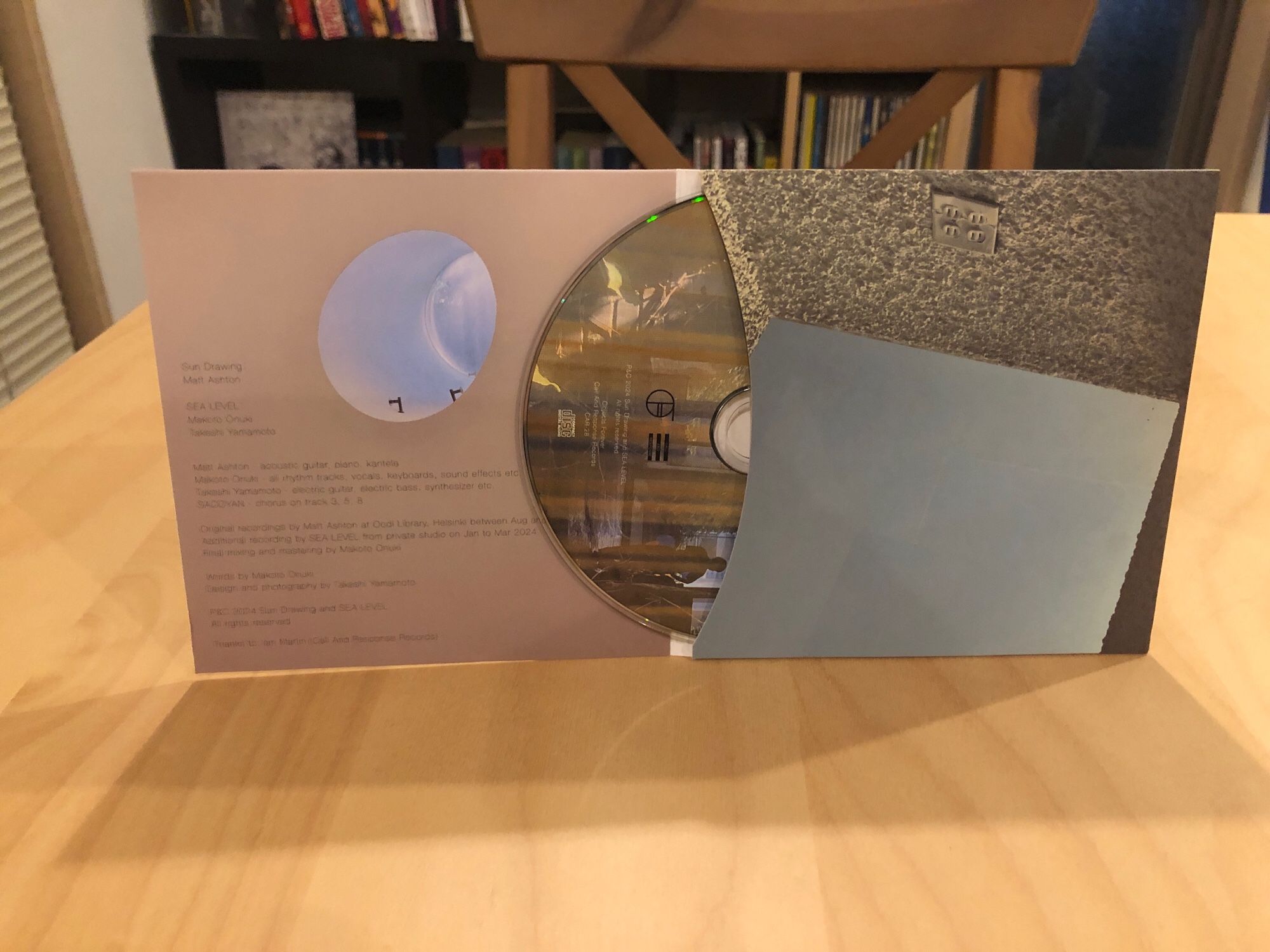 The Sun Drawing + Sea Level album “Afternoons At The Library” CD jacket open with the CD poking out of the sleeve a bit