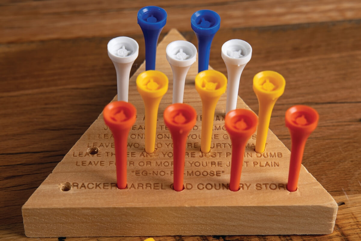 cracker barrel golf tee game thing. it's a wooden triangle with a bunch of holes, and you have to move these golf tees around in the holes, jumping over each other and removing them, it's a whole thing