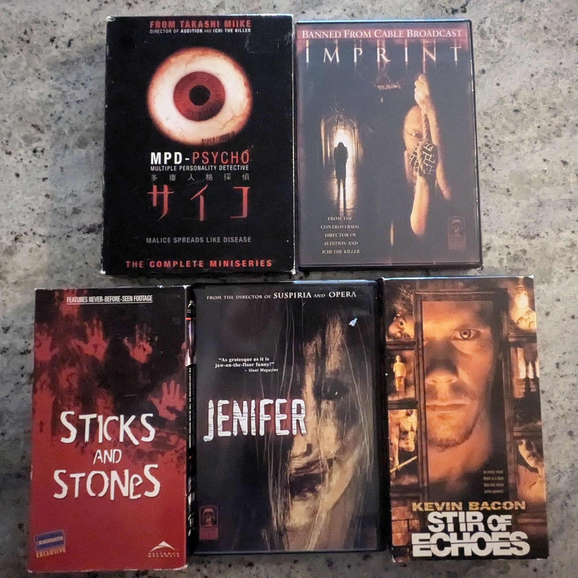 DVDs of Takashi Mike's MPD Psycho and Imprint. Masters of Horror Jenifer dvd. VHS copies of the Blockbuster Video exclusive Blair Witch Sticks and Stones, and Stir of Echoes.