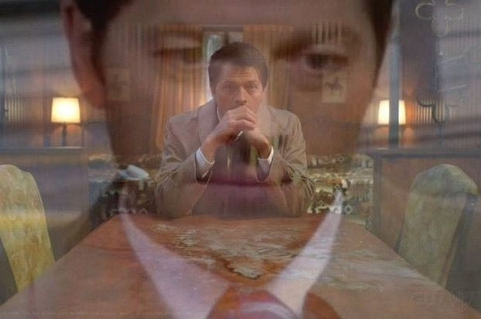 A closeup of Castiel, a deeply troubled guy in a trenchcoat, staring off into the distance, superimposed over a long shot of Castiel staring off into the distance