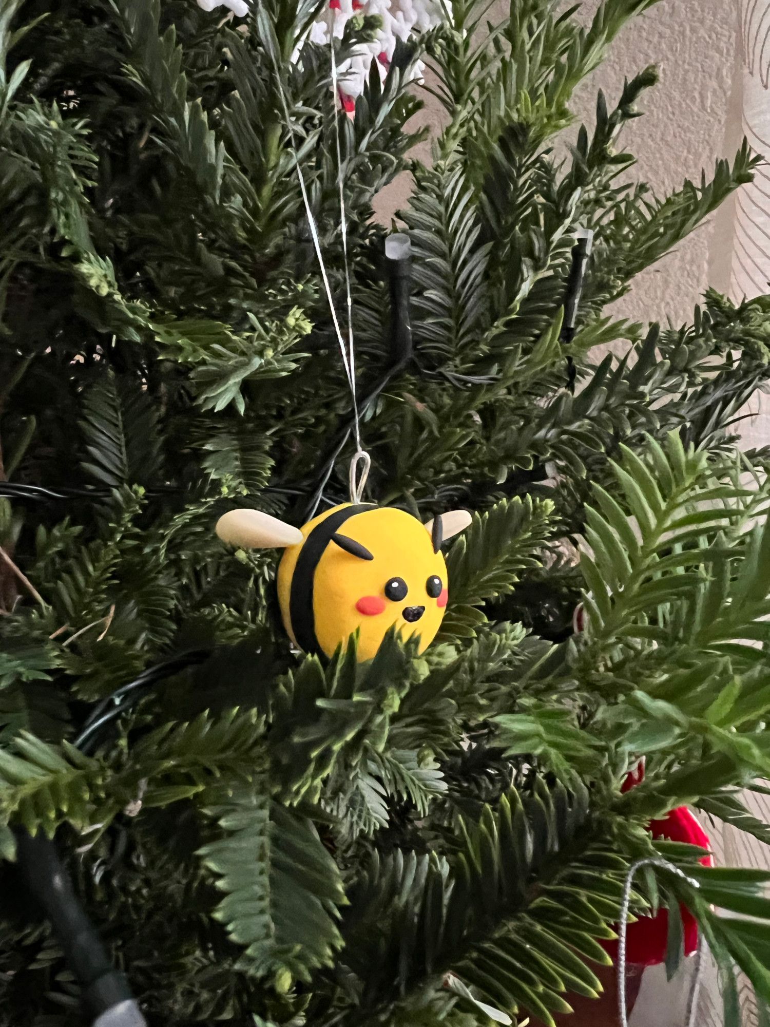 Silly little round bee on a christmas tree.