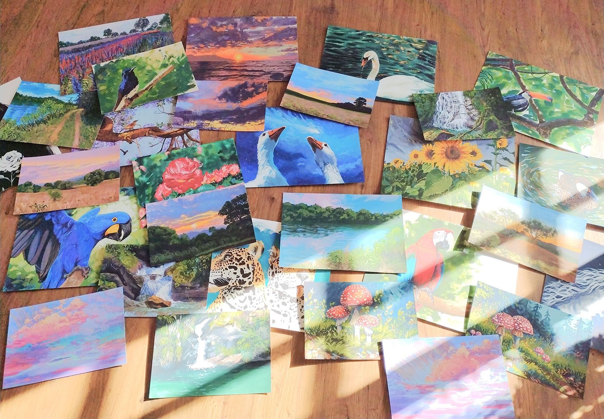 A collection of 30 gouache paintings on the floor with sun rays coming from the side window.
#natureart #artchallenge #traditionalart #gouacheart #paintings #Brart