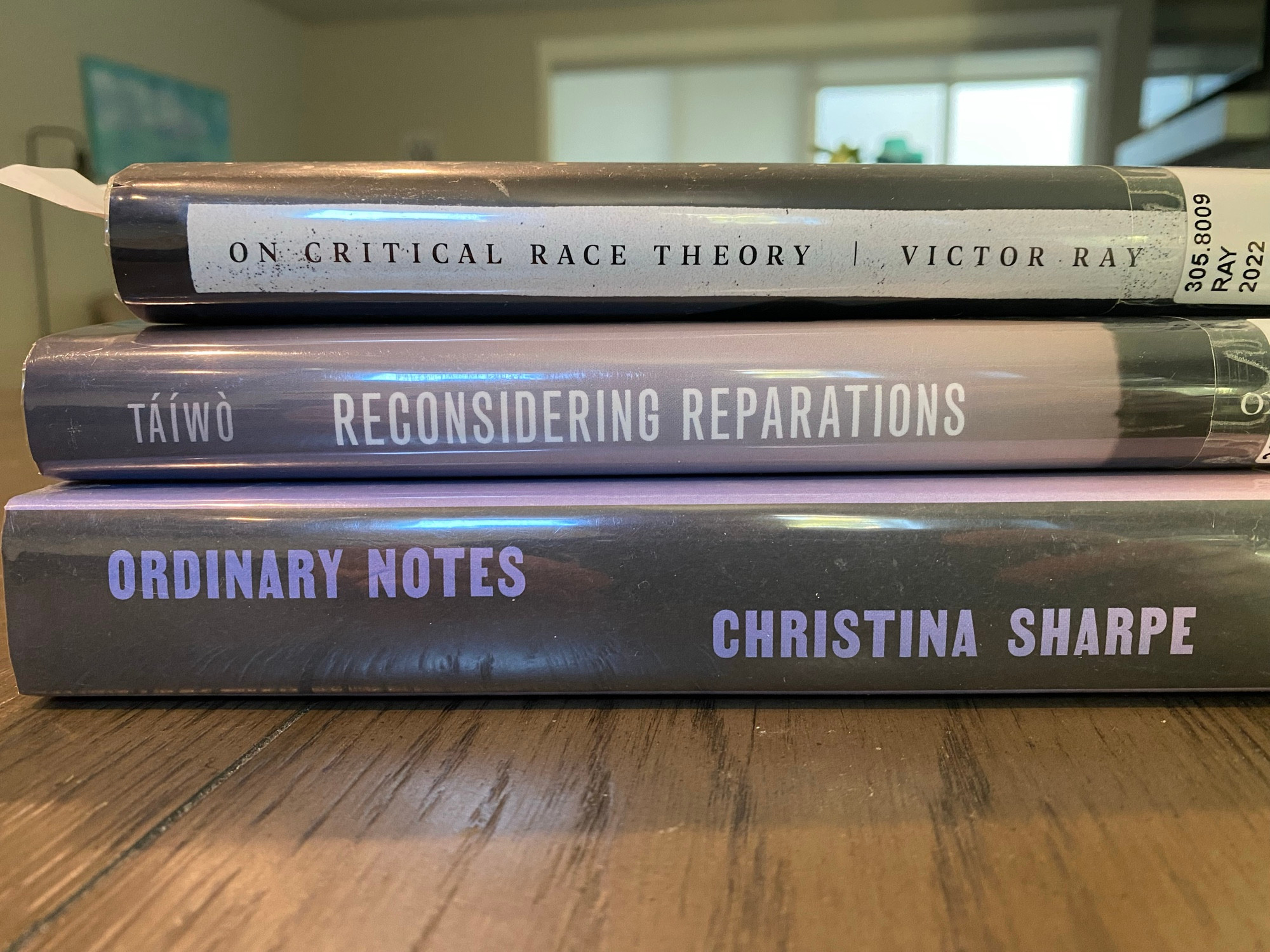 A stack of three books: Victor Ray’s “On Critical Race Theory,” Olúfémi Táíwò’s “Reconsidering Reparations,” anf Christina Sharpe’s “Ordinary Notes”