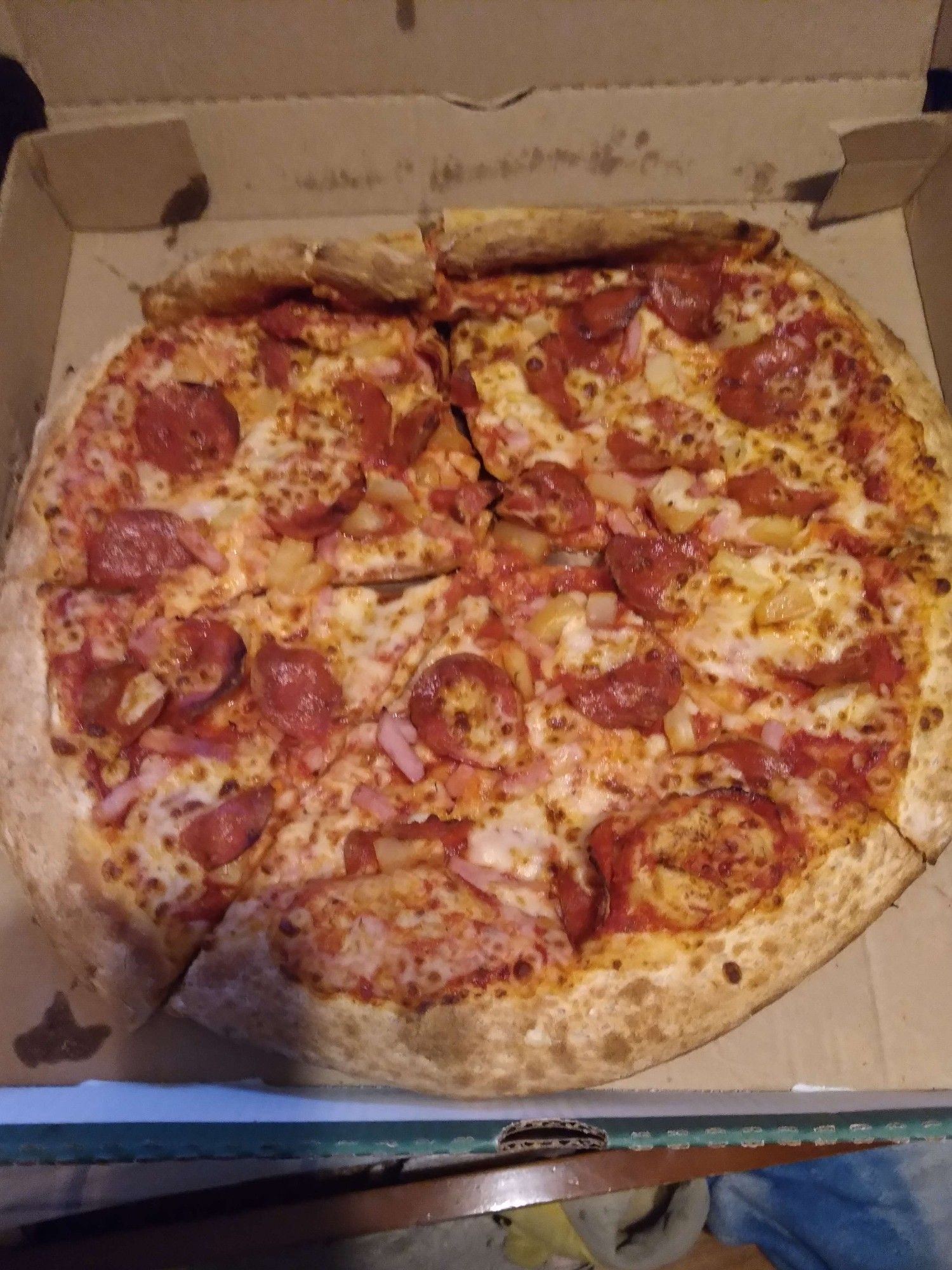 Image of a pepperoni, Canadian bacon, and pineapple (fite me), pizza from the delicious yet expensive Papa Johns