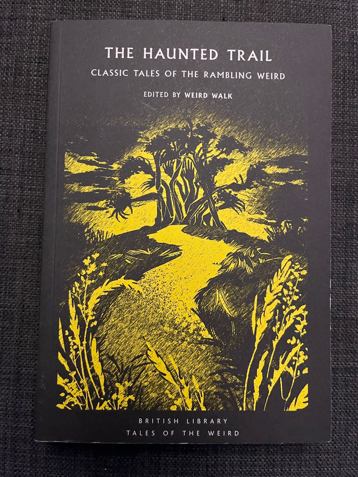 Black and yellow book cover - The Haunted Trail: Classic Tales of the Rambling Weird, edited by Weird Walk